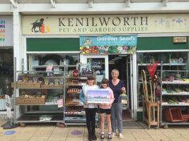 Kenilworth Pet & Garden Supplies'proprietor, Betty, with her grandchildren, hold the Advent Calendar